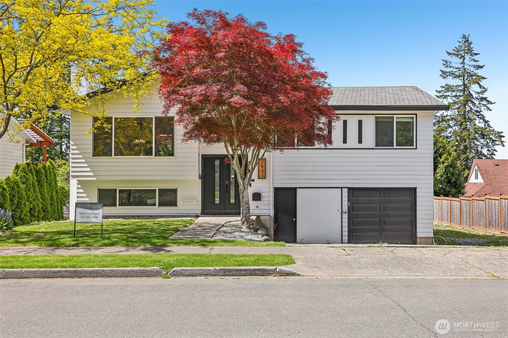 a front view of a house with a yard and garage
