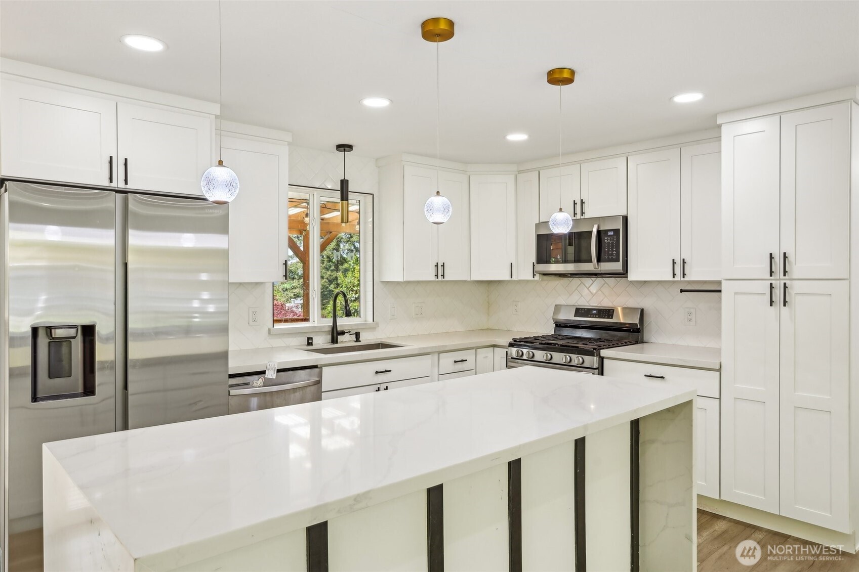 2531 Smithers Avenue South Renton, WA 98055 - Photo 11 of 24 a kitchen with stainless steel appliances a sink a stove a refrigerator cabinets and a window