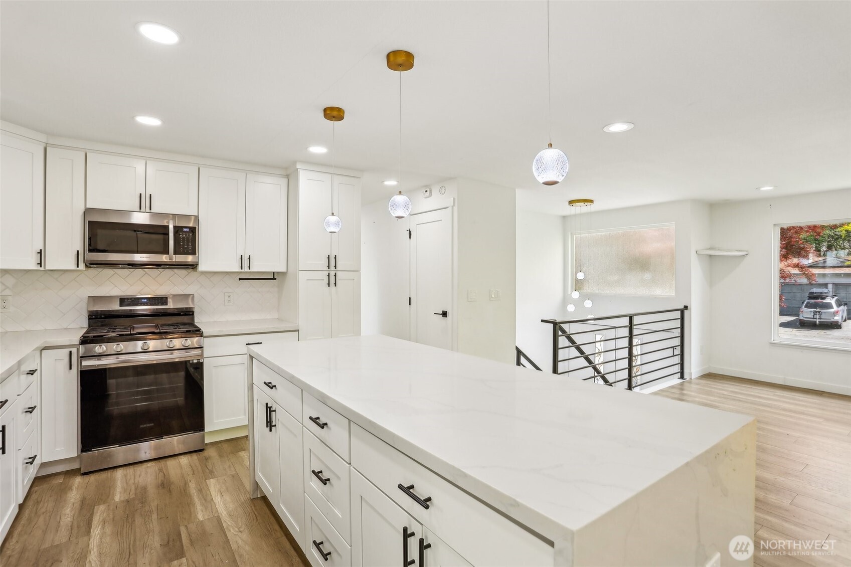 2531 Smithers Avenue South Renton, WA 98055 - Photo 12 of 24 a kitchen with stainless steel appliances granite countertop a stove a sink a refrigerator white cabinets and a refrigerator with wooden floor