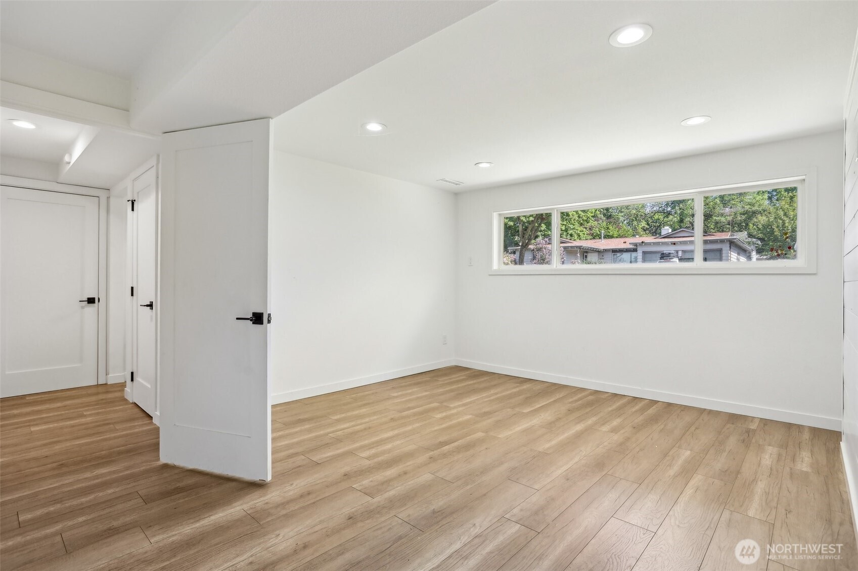 2531 Smithers Avenue South Renton, WA 98055 - Photo 19 of 24 an empty room with wooden floor cabinet and windows