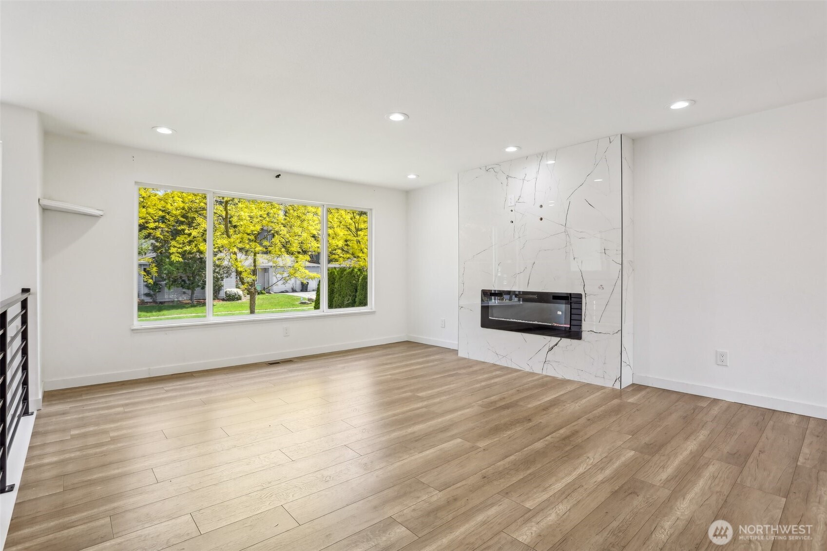 2531 Smithers Avenue South Renton, WA 98055 - Photo 5 of 24 an empty room with large windows and a fireplace