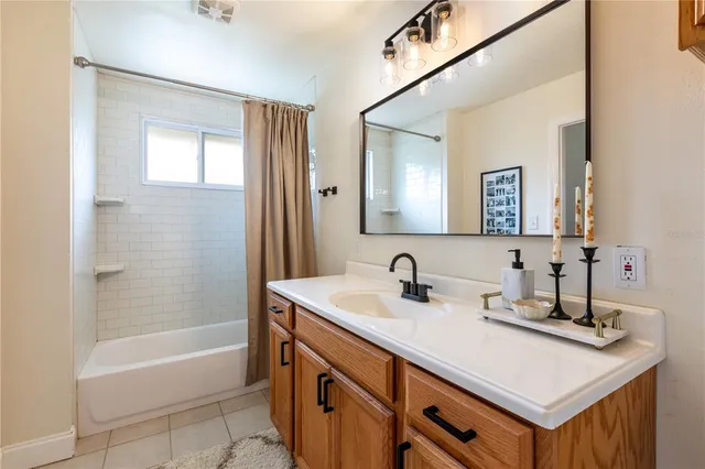 a bathroom with a sink a tub and a mirror