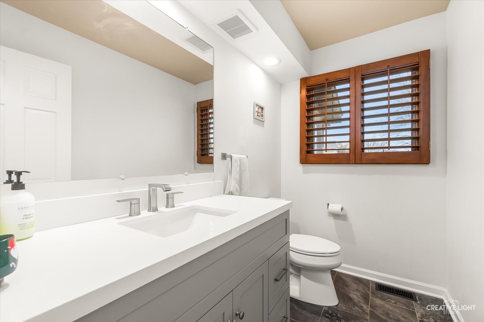1255 East Bailey Road Naperville, IL 60565 - Photo 10 of 34 a bathroom with a sink a toilet and a large mirror
