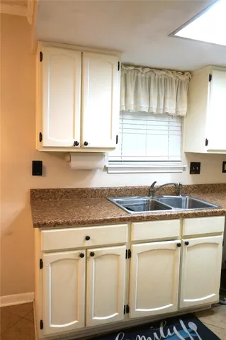 a kitchen with a sink cabinets and window