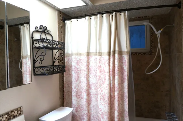 a bathroom with a shower toilet and sink