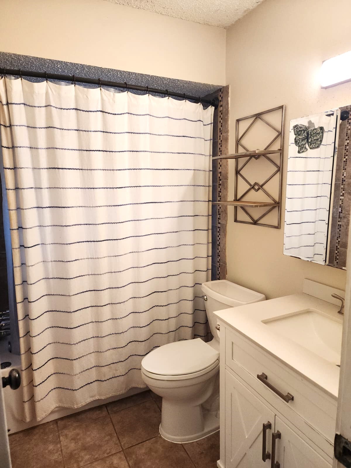 718 Silverpines Road Houston, TX 77062 - Photo 36 of 49 a bathroom with a sink a toilet and shower curtain