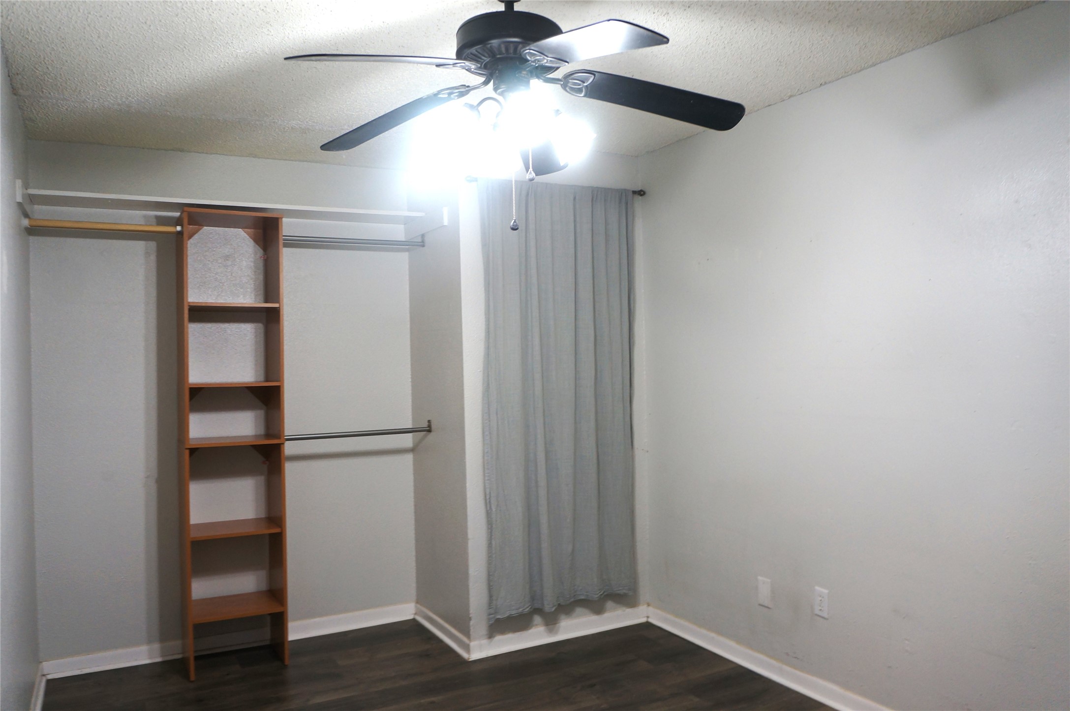 718 Silverpines Road Houston, TX 77062 - Photo 44 of 49 an empty room with wooden floor closet fan and windows