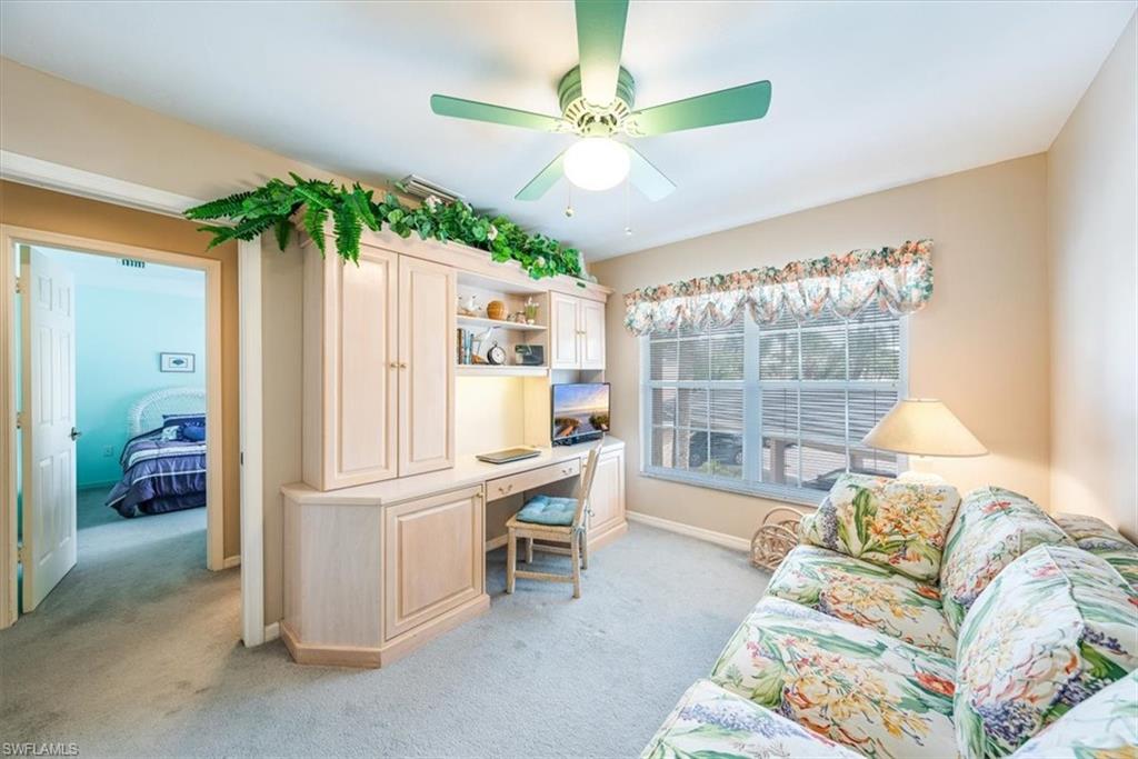 5637 Turtle Bay Drive, Unit 16 Naples, FL 34108 - Photo 12 of 22 a living room with furniture and a large window
