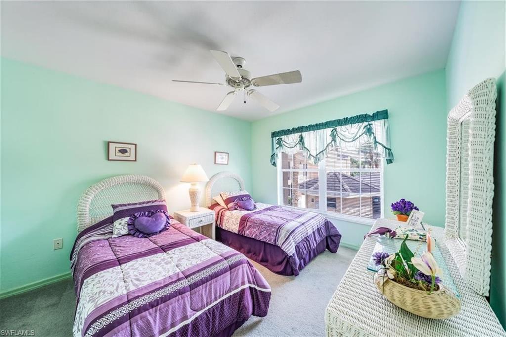5637 Turtle Bay Drive, Unit 16 Naples, FL 34108 - Photo 13 of 22 a bedroom with two beds and a window