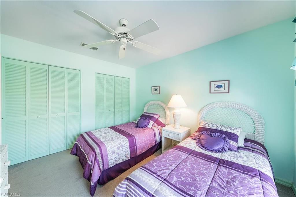 5637 Turtle Bay Drive, Unit 16 Naples, FL 34108 - Photo 14 of 22 a bedroom with two beds and painted walls