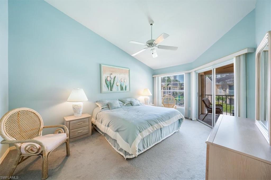 5637 Turtle Bay Drive, Unit 16 Naples, FL 34108 - Photo 16 of 22 a spacious bedroom with a bed a table and large window