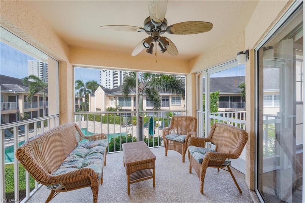 5637 Turtle Bay Drive, Unit 16 Naples, FL 34108 - Photo 20 of 22 a living room with furniture and a large window