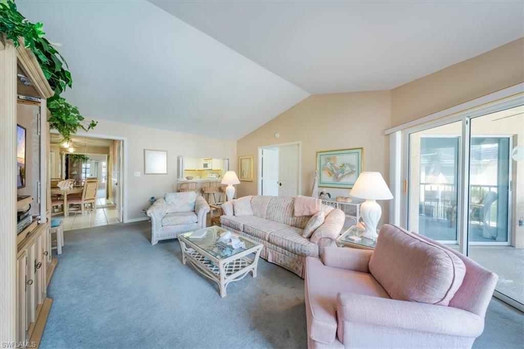 5637 Turtle Bay Drive, Unit 16 Naples, FL 34108 - Photo 2 of 22 a living room with furniture and a large window