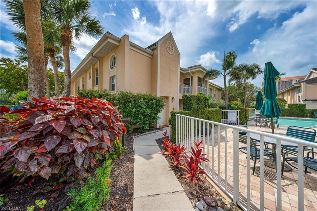 5637 Turtle Bay Drive, Unit 16 Naples, FL 34108 - Photo 21 of 22 a view of a house with wooden fence