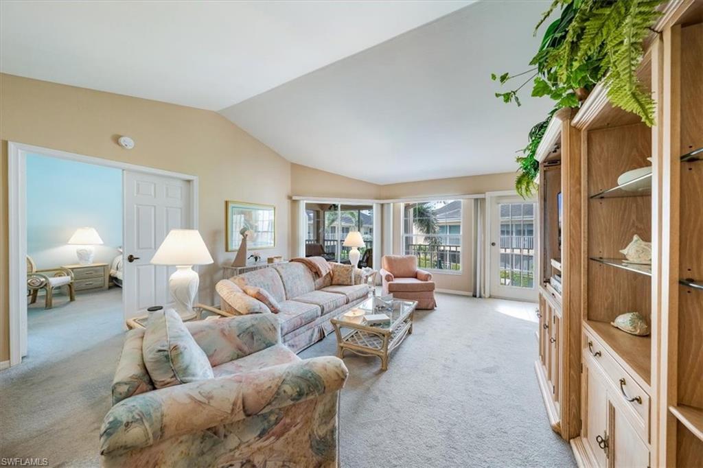 5637 Turtle Bay Drive, Unit 16 Naples, FL 34108 - Photo 3 of 22 a living room with furniture and a large window
