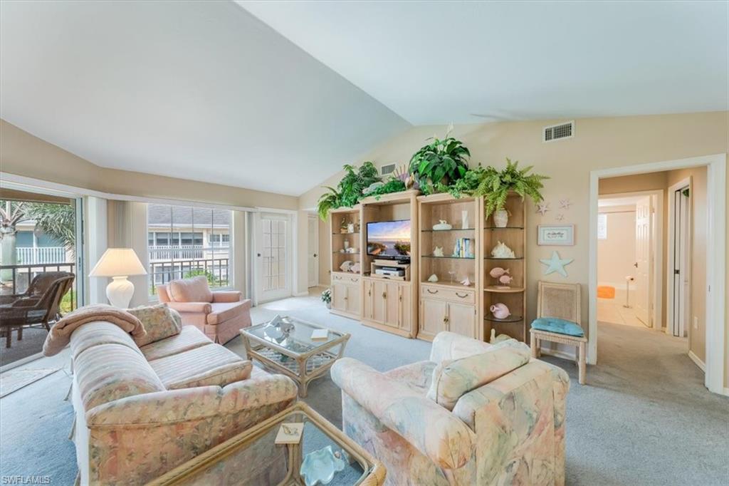 5637 Turtle Bay Drive, Unit 16 Naples, FL 34108 - Photo 4 of 22 a living room with furniture and a large window