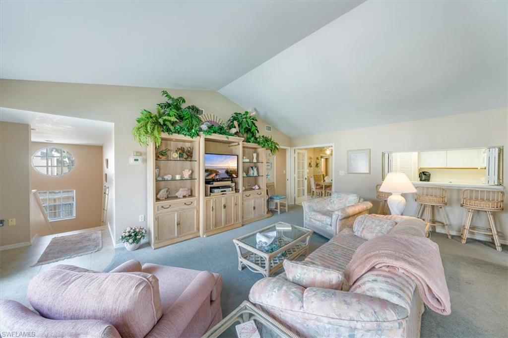 5637 Turtle Bay Drive, Unit 16 Naples, FL 34108 - Photo 5 of 22 a living room with furniture and a large window