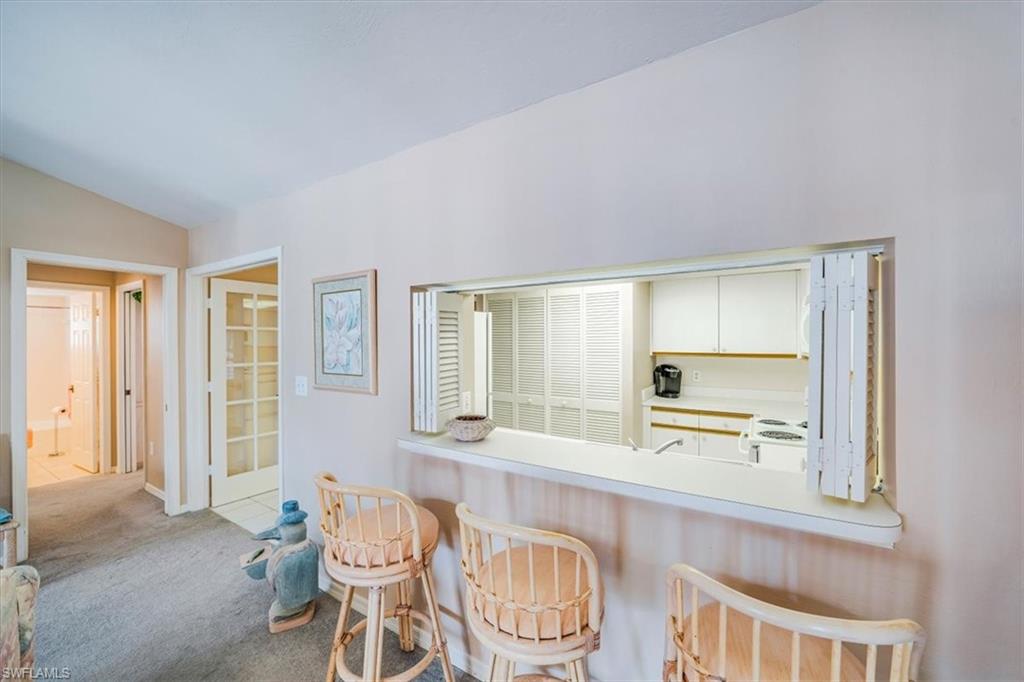 5637 Turtle Bay Drive, Unit 16 Naples, FL 34108 - Photo 6 of 22 a dining room with furniture and window