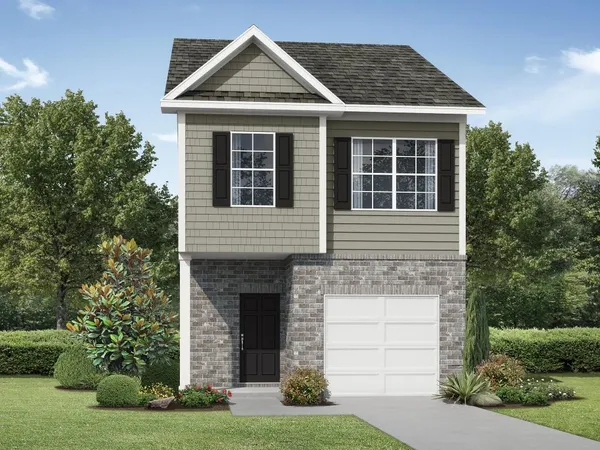 a front view of a house with a yard and garage