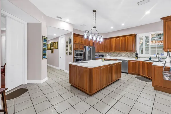 a kitchen with stainless steel appliances granite countertop a sink counter space cabinets and a window
