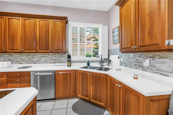 a kitchen with stainless steel appliances wooden cabinets a sink and a stove