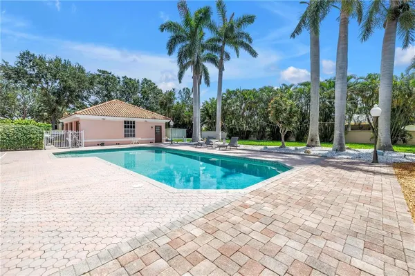 a house with swimming pool in front of it