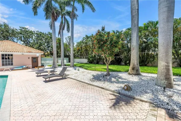 a view of a house with backyard and sitting area