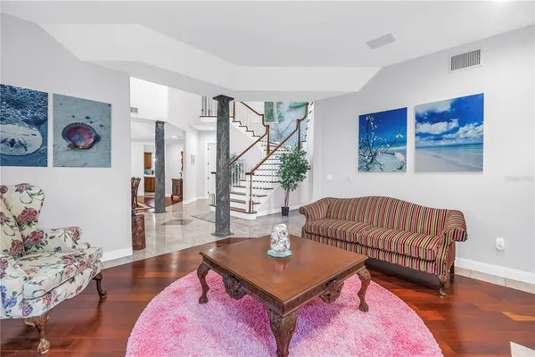 a living room with furniture and wooden floor