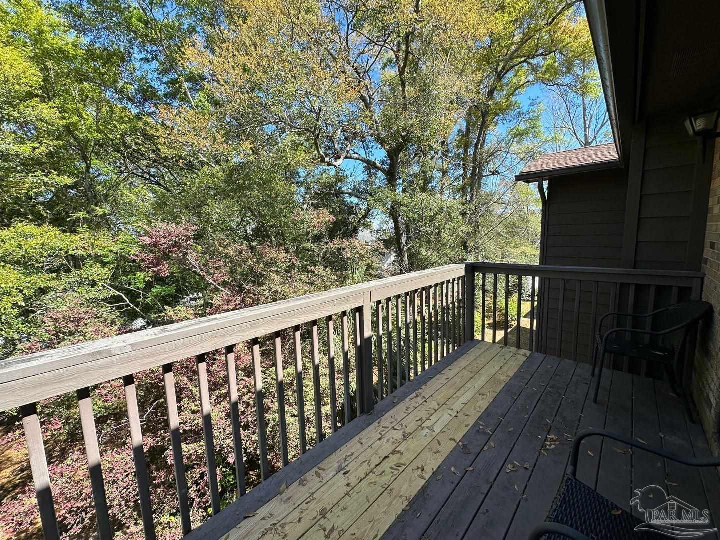 4831 East Olive Road, Unit 4D Pensacola, FL 32514 - Photo 15 of 17 a balcony with wooden floor and fence