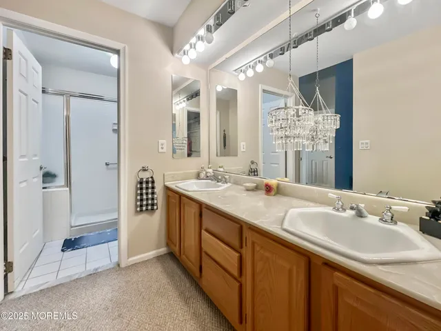 a bathroom with a granite countertop sink mirror and double