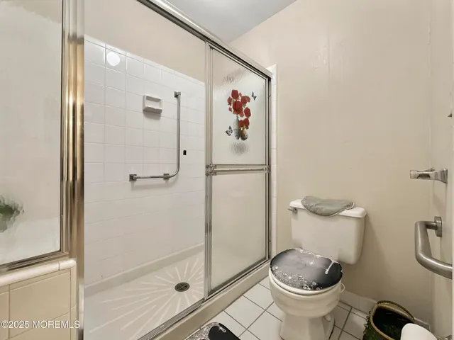 a bathroom with a granite countertop toilet and a shower