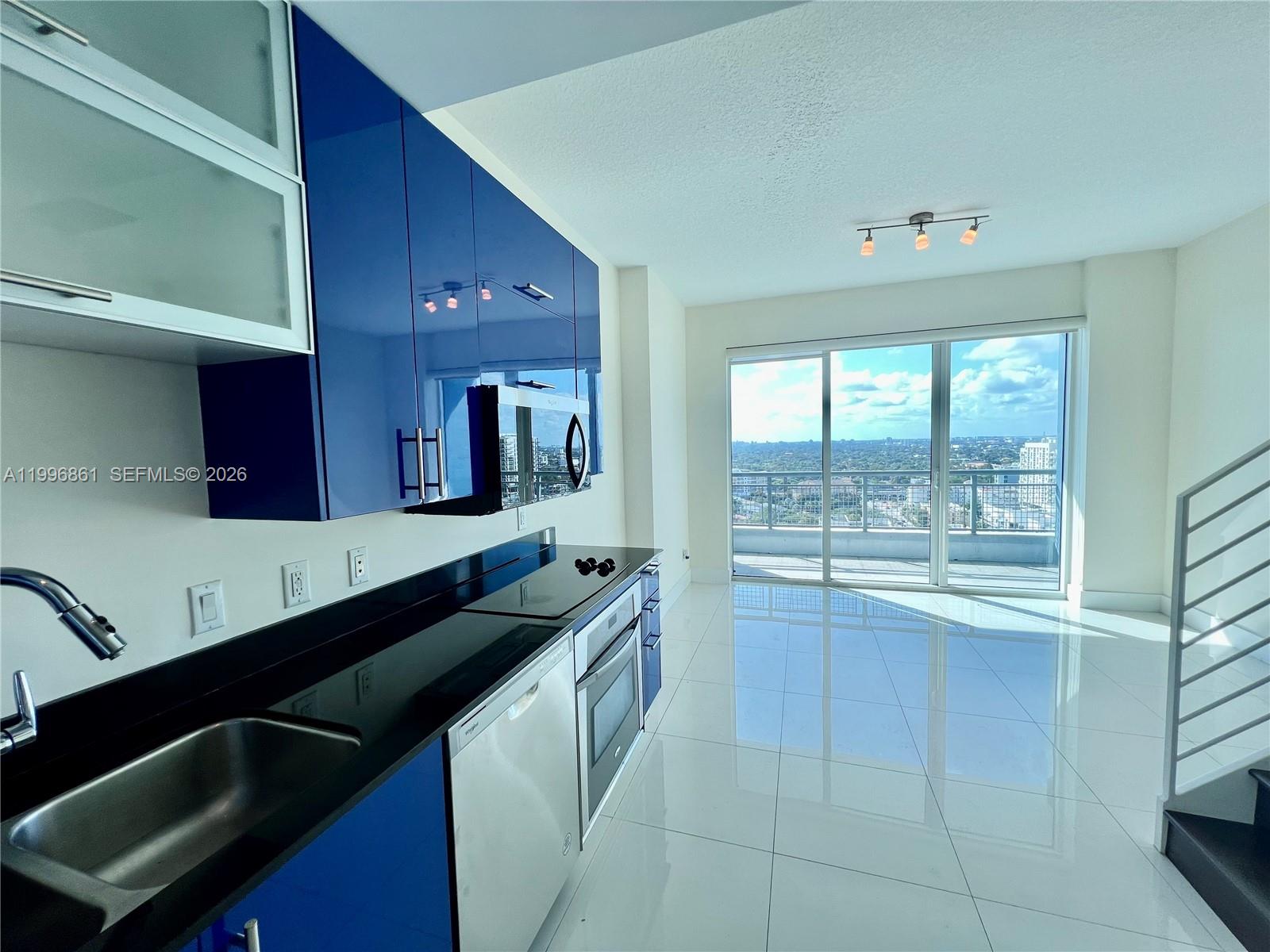 60 Southwest 13th Street, Unit 1611 Miami, FL 33130 - Photo 1 of 28 a kitchen with a sink and a stove top oven