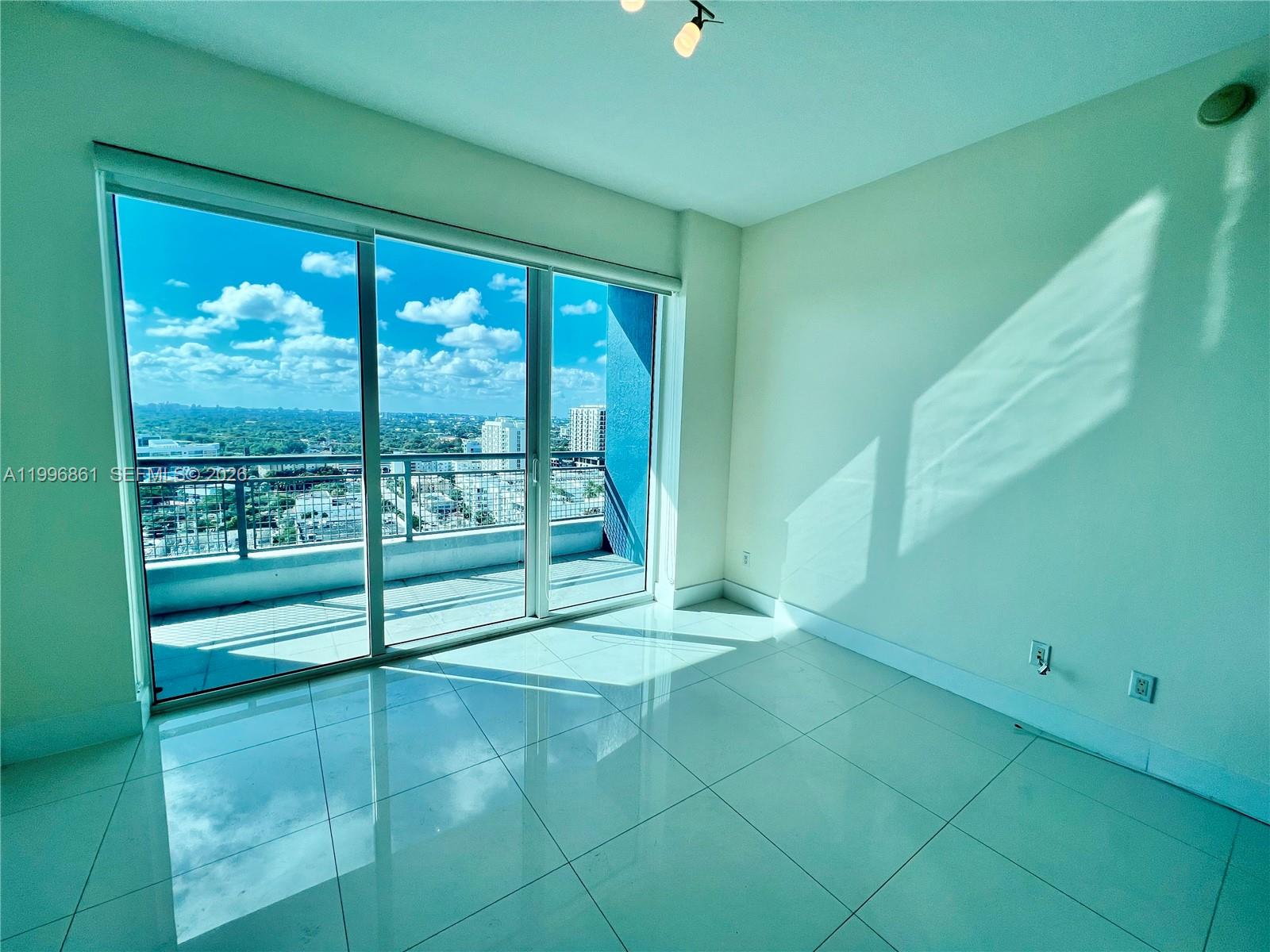60 Southwest 13th Street, Unit 1611 Miami, FL 33130 - Photo 13 of 28 a view of an empty room with a window