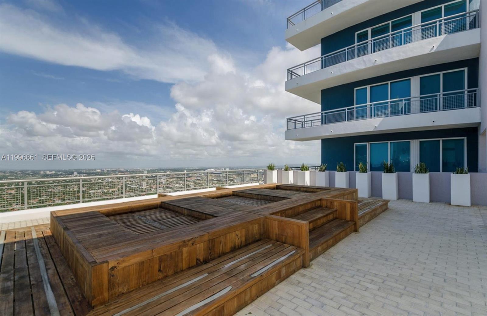 60 Southwest 13th Street, Unit 1611 Miami, FL 33130 - Photo 17 of 28 a view of a roof deck with couches and wooden floor