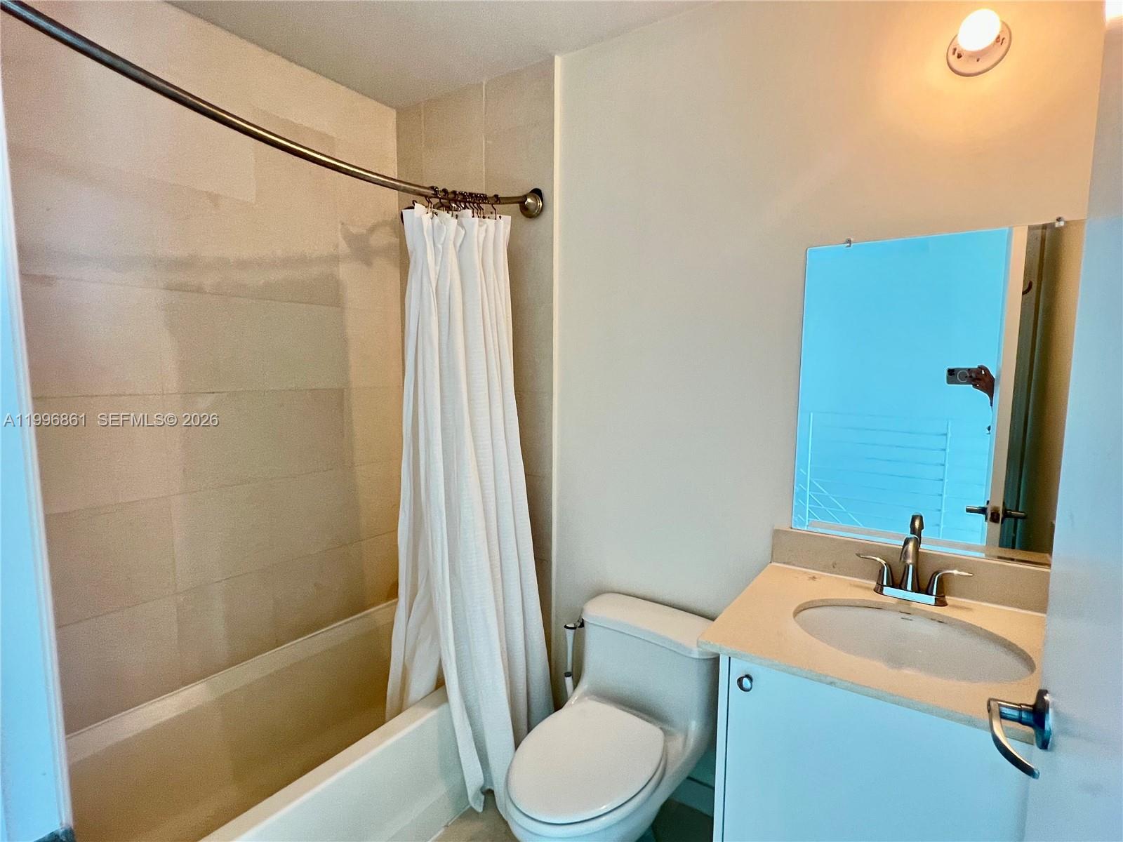 60 Southwest 13th Street, Unit 1611 Miami, FL 33130 - Photo 18 of 28 a bathroom with a sink toilet and shower