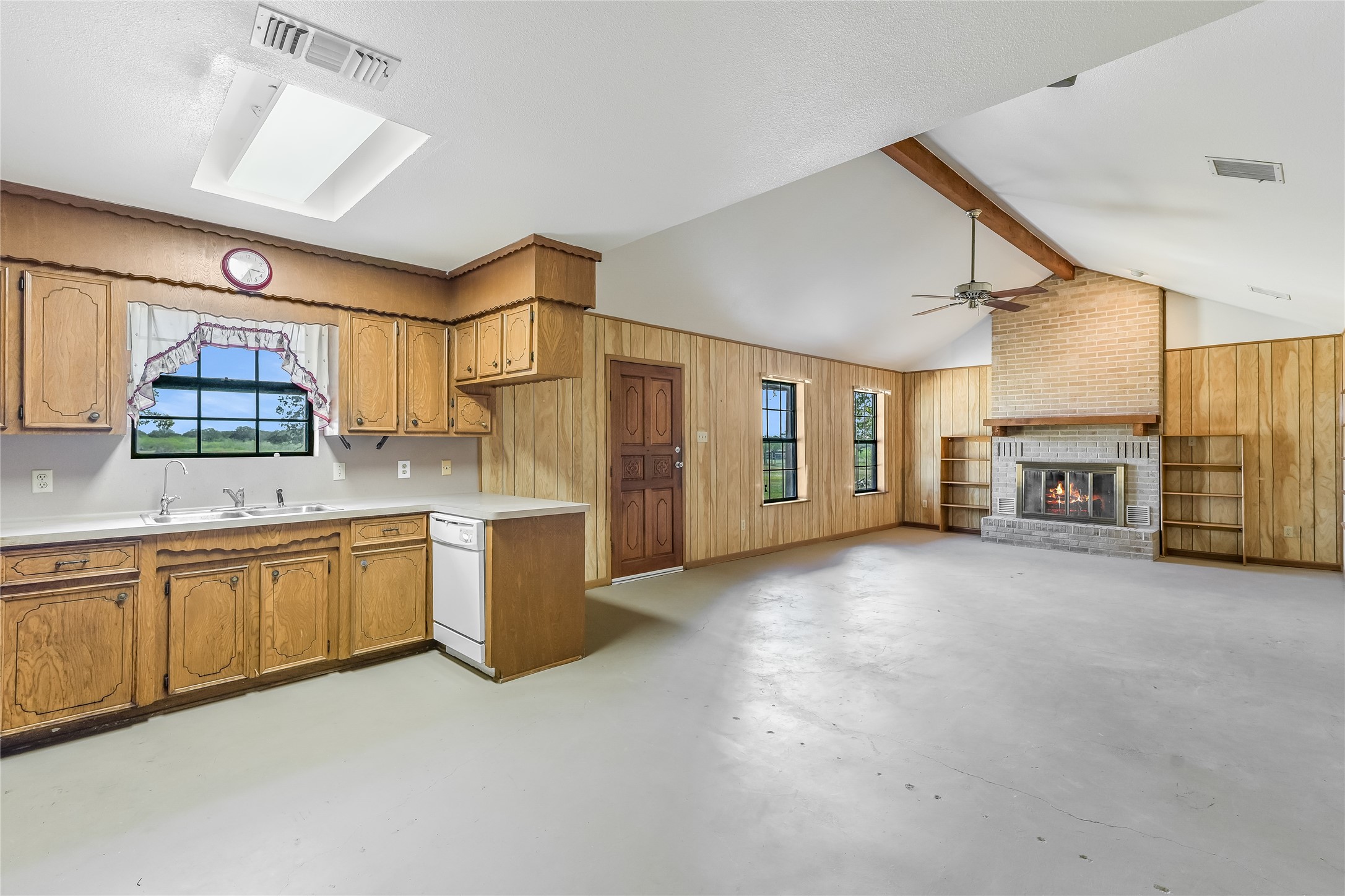 5637 Jeddo Road Waelder, TX 78959 - Photo 12 of 37 a large kitchen with a large window and stainless steel appliances