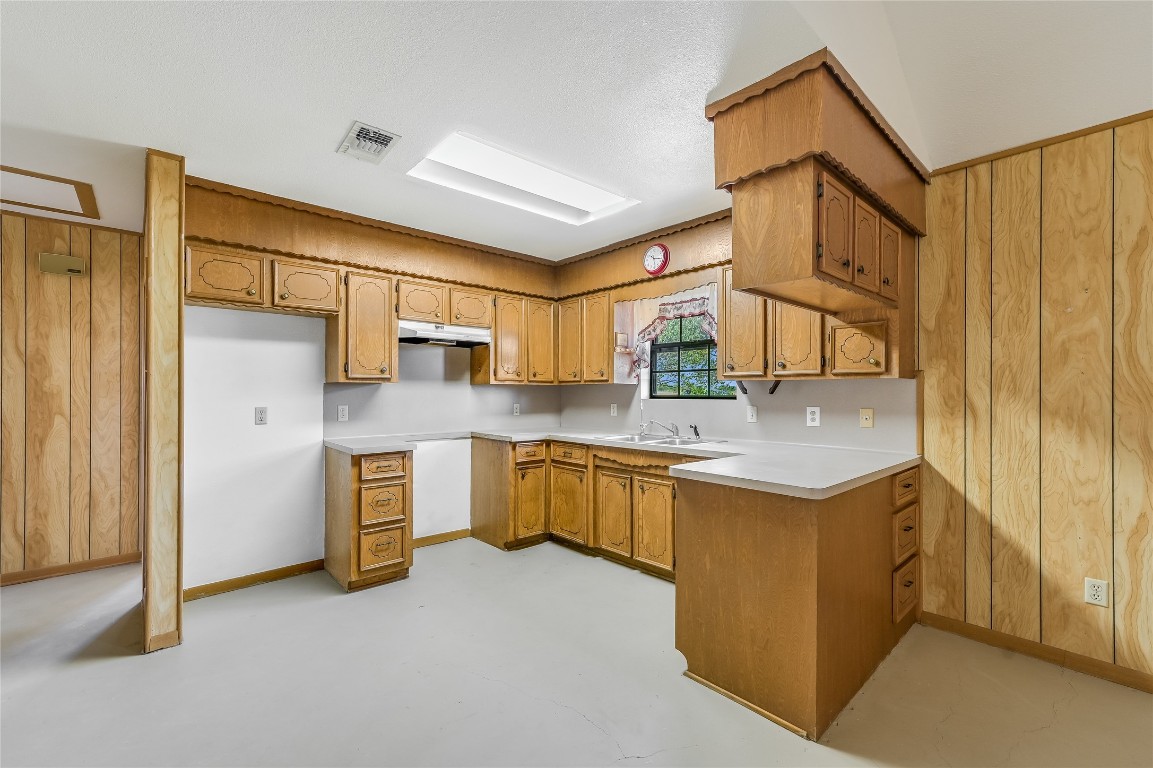 5637 Jeddo Road Waelder, TX 78959 - Photo 13 of 37 a kitchen with stainless steel appliances granite countertop a sink and cabinets