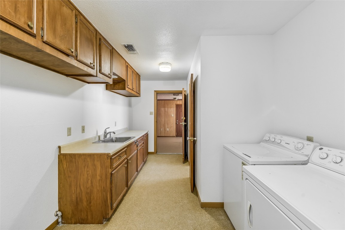 5637 Jeddo Road Waelder, TX 78959 - Photo 14 of 37 a hallway with a sink a washer and dryer
