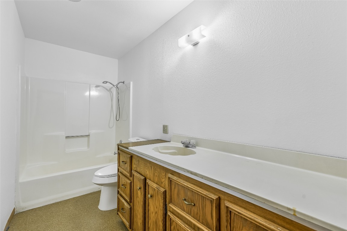 5637 Jeddo Road Waelder, TX 78959 - Photo 16 of 37 a bathroom with a sink a toilet and shower