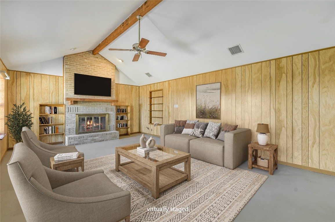 5637 Jeddo Road Waelder, TX 78959 - Photo 4 of 37 a living room with furniture a fireplace and a flat screen tv