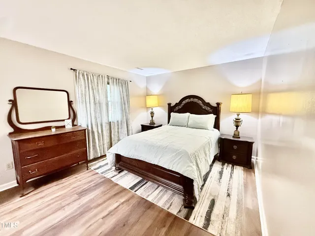 a bed room with a bed window and a table