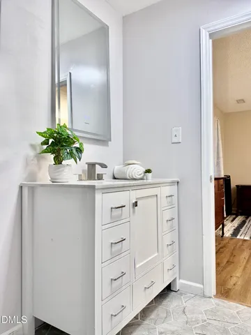 a bathroom with a sink toilet and mirror