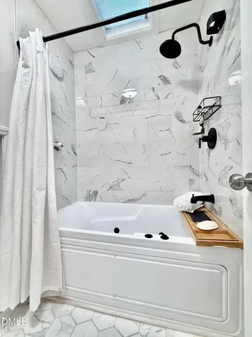 a blue house with a large window and wooden fence