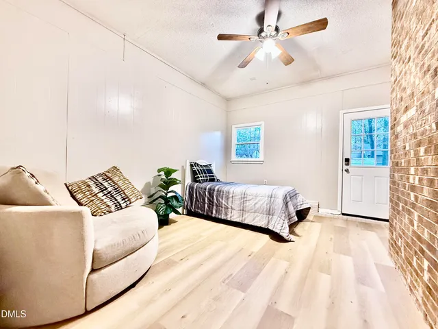 a view of deck with wooden floor and large trees