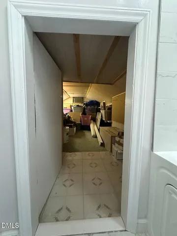 a backyard of a house with barbeque oven table and chairs