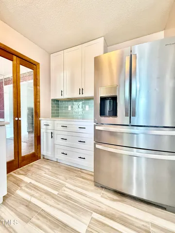 a kitchen with a refrigerator and a stove