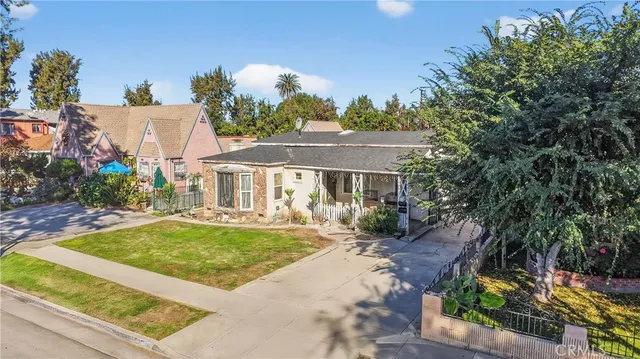 a view of a house with swimming pool and sitting area