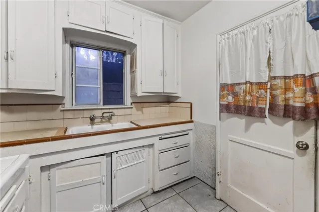 a kitchen with a stove a sink and a refrigerator