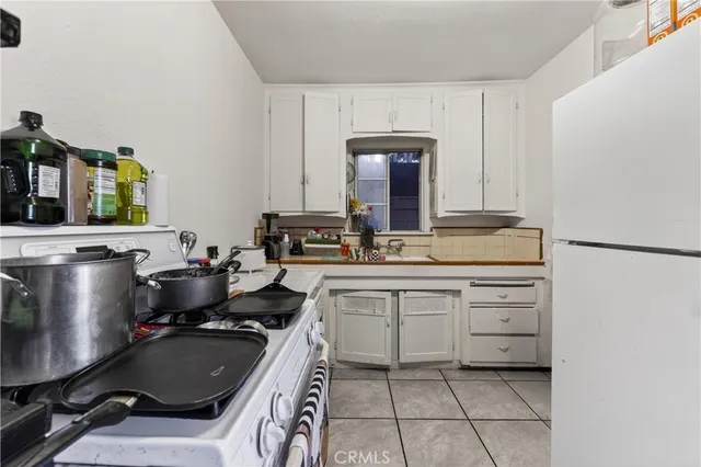a bedroom with a bed a dresser and book shelf