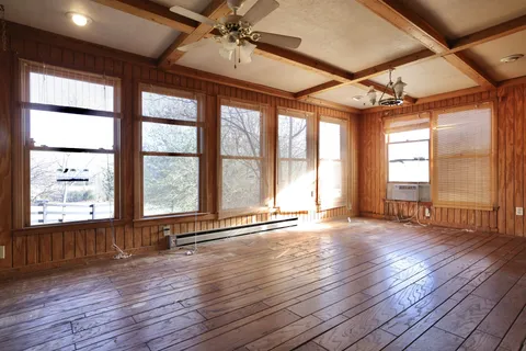 a view of room with wooden floor and large window